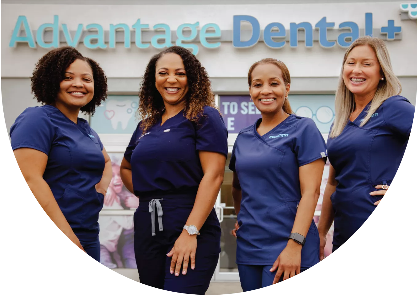 Advantage Dental employees smiling in front of a dental practice.